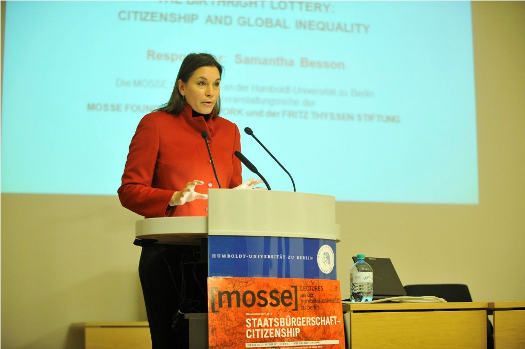 Besson speaks from the podium