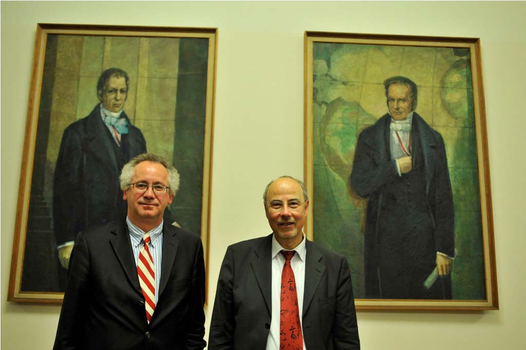Danuser poses in front of the portraits of the Humboldt brothers