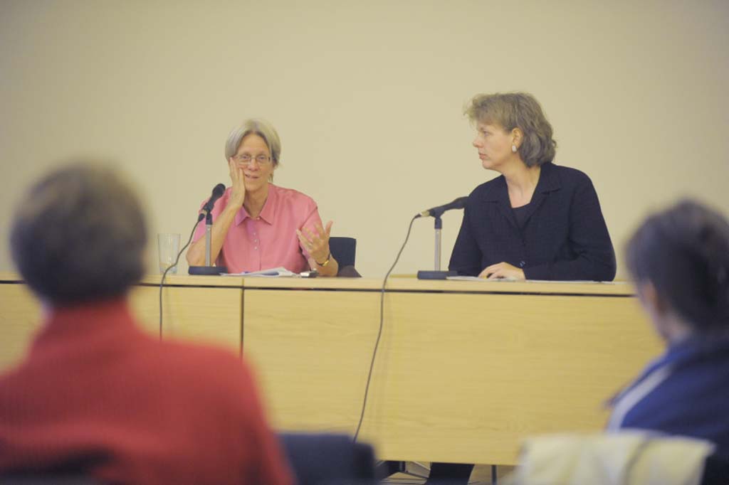 Ackerman addresses the audience, seated next to Ulrike Vedder