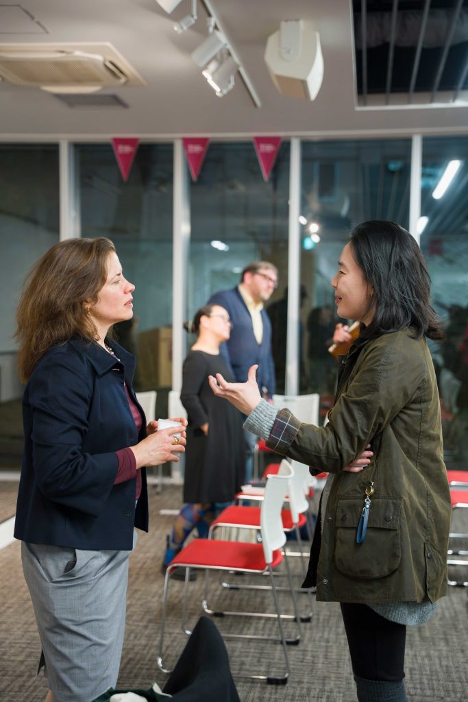 Kristin Surak speaks with an attendee