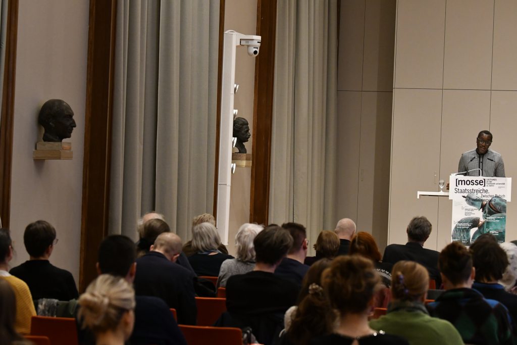 the audience looks on